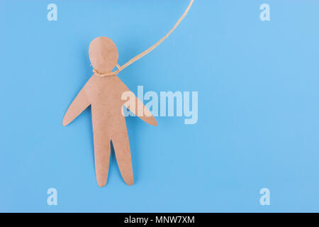 hang oneself concept. paper person on blue background Stock Photo