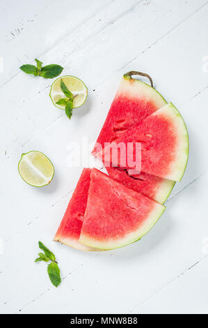 Watermelon slice and lime on rustic wood background. Stock Photo