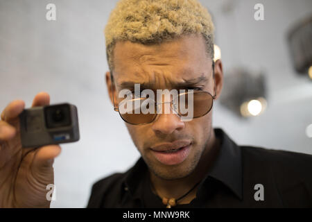 Stylish young man with glasses with camera in hands. Stock Photo