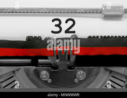 32 Number text written by an old typewriter on white sheet Stock Photo
