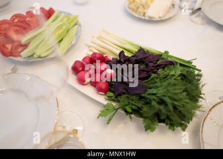 beautifully decorated white table with festive food Stock Photo