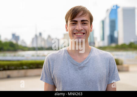 Young handsome man relaxing at the park Stock Photo