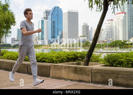 Young handsome man jogging at the park Stock Photo