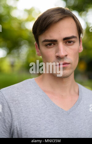 Young handsome man relaxing at the park Stock Photo