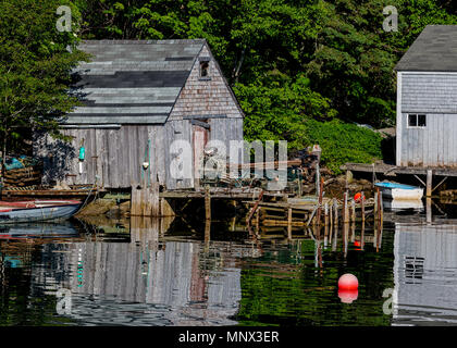 Old rishing shed reflecting in still waters along the shores of Nova Scotia, Canada. Stock Photo