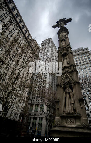 Crucifix agains buildings in the cemetery of Trinity Church in Manhattan, New York, USA. April 30, 2018. Stock Photo
