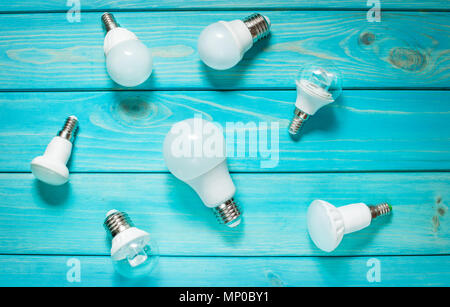 Set of different row LED bulbs on blue wood background Stock Photo