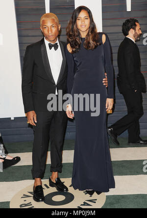 Pharrell Williams and Helen Lasichanh arriving to the Chanel show