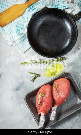 Pork fillet wrapped in bacon on concrete background Stock Photo