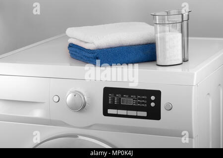 the upper part of the washing machine with a towel and a container with detergent Stock Photo