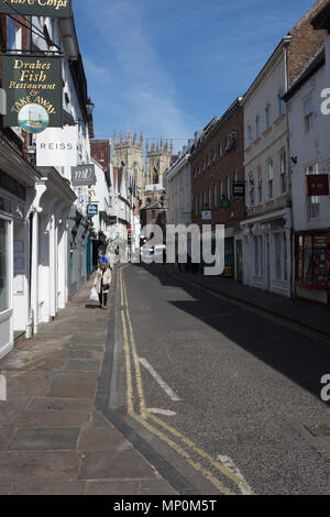 Low Petergate, York, England. A shopping street in the city of York, England with the towers of York Minster in the background Stock Photo