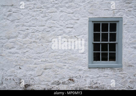 Old Gray Window on a stone whitewashed cottage Stock Photo