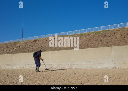 Metal detectorist searching for lost treasures both ancient and new. Stock Photo