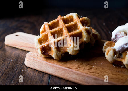 Plain Belgium Waffle on wooden surface. Traditional Food. Stock Photo