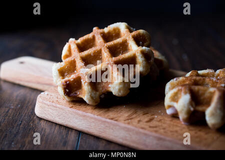 Plain Belgium Waffle on wooden surface. Traditional Food. Stock Photo