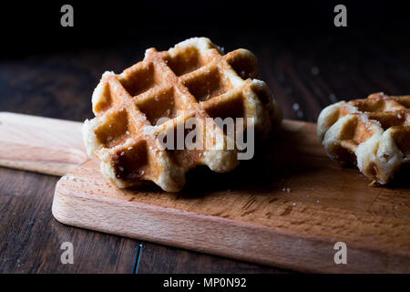 Plain Belgium Waffle on wooden surface. Traditional Food. Stock Photo