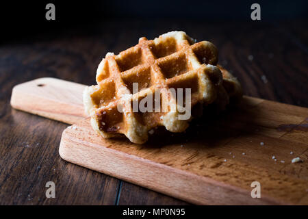 Plain Belgium Waffle on wooden surface. Traditional Food. Stock Photo