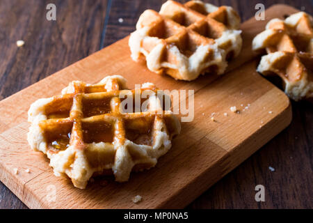 Belgium Waffle with Maple Syrup on wooden surface. Traditional Food. Stock Photo