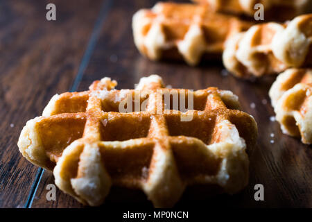 Plain Belgium Waffle on wooden surface. Traditional Food. Stock Photo