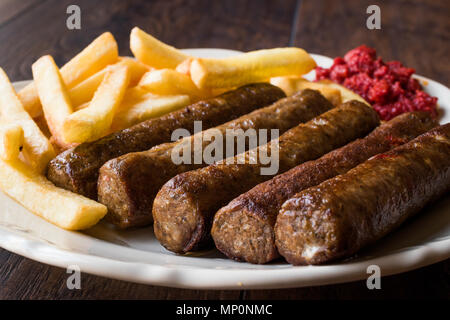 Balkan Cevapcici Kofta / Kofte with Potatoes and Tomato Sauce. Traditional Food. Stock Photo