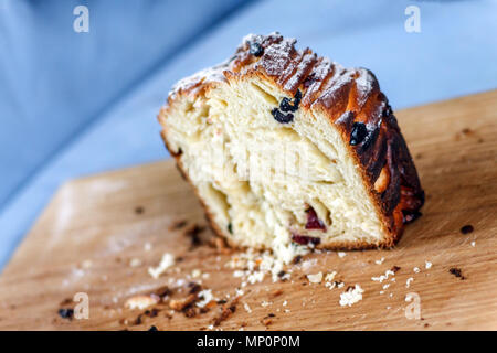 Easter cake-crunch with raisins and candied fruit sliced on the board. Close-up Stock Photo