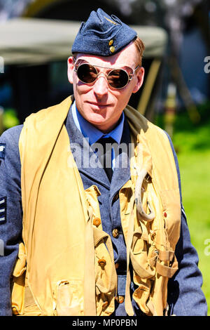 Popular Salute to the 40s event at Sandwich town, Kent. World war two young man re-enactor, RAF pilot with life jacket, mae-west, on. Close up. Facing Stock Photo