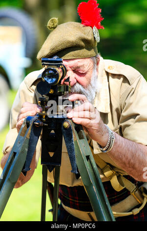 Salute to the 40s popular event at Sandwich in Kent. World war two Scottish soldier from the Desert Rats re-enactment group using a surveyor on tripod Stock Photo