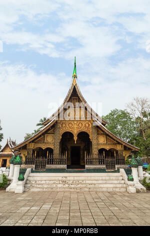Front view of the Buddhist Wat Xieng Thong temple ('Temple of the Golden City') in Luang Prabang, Laos. Stock Photo