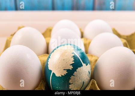 Happy Easter, a organic blue easter egg standing in the middle of the white eggs, easter holiday decorations, easter concept backgrounds Stock Photo