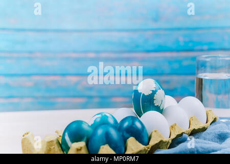Happy easter, organic blue easter egg standing on the white color eggs wait for painting, easter holiday decorations, easter concept backgrounds Stock Photo