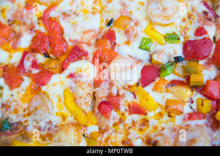 Slice of hot pizza large cheese lunch or dinner crust seafood meat topping sauce. with bell pepper vegetables delicious tasty fast food italian tradit Stock Photo