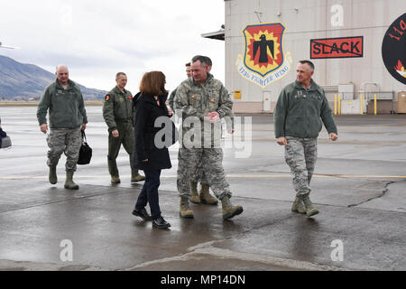 U.S. Air Force Col. Jeffrey Smith, Commander, 173rd Fighter Wing, speaks with Oregon Governor Kate Brown after her arrival, March 13, 2018, at Kingsley Field, Ore. Brown, who traveled to Klamath with Brig. Gen. James Kriesel, Oregon Air National Guard Commander, and Dave Stuckey, Deputy Director, Oregon Military Department, is visiting both the base and the community leadership. Stock Photo