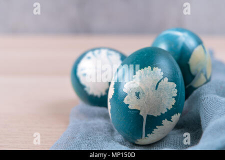 Happy easter, three organic blue easter eggs standing on the wooden table, easter holiday decorations, easter concept backgrounds with copy space Stock Photo