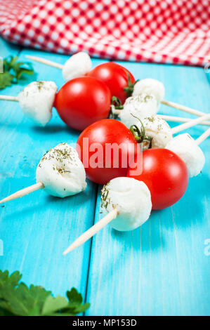 Cherry tomatoes with mozzarella on a stick. Stock Photo