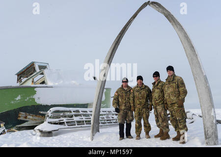 Maj. Gen. Mark O'Neil, left, commanding general, US Army Alaska, and his leadership team pose for a photo below a whale bone arch in Utqiaġvik, Alaska, March 14, as part of the U.S. Army Alaska-led Joint Force Land Component Command in support of Alaskan Command's exercise Arctic Edge 18 conducted under the authority of U.S. Northern Command. Arctic Edge 2018 is a biennial, large-scale, joint-training exercise that prepares and tests the U.S. military's ability to operate tactically in the extreme cold-weather conditions found in Arctic environments. Stock Photo