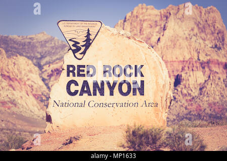 Rock boulder sign for Red Rock Canyon in Las Vegas Nevada with mountains in the background Stock Photo