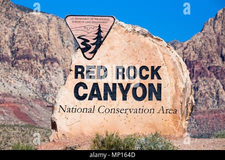 Rock boulder sign for Red Rock Canyon in Las Vegas Nevada with mountains in the background Stock Photo