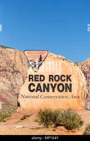 Rock boulder sign for Red Rock Canyon in Las Vegas Nevada with mountains in the background Stock Photo