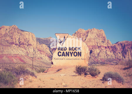 Rock boulder sign for Red Rock Canyon in Las Vegas Nevada with mountains in the background Stock Photo