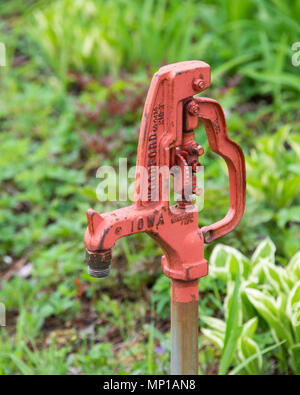 A Woodford Freezeless Yard Hydrant in a garden on Osborne Point in Speculator, NY USA Stock Photo