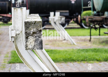 End of railway tracks at the station. A white construction blocking the passage of locomotives. Season of the spring. Stock Photo