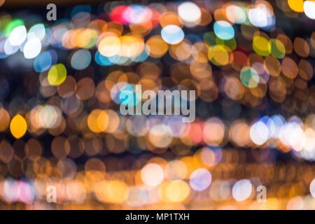 Defocused bright city lights blur with buildings and traffic Stock Photo