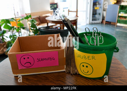 16 May 2018, Germany, Berlin: Two trays for 'schmutzig' (lit. dirty) and 'sauber' (lit. clean) utensils which can be used for bottling the products at the zero waste shop 'Der Sache wegen - einfach richtig einkaufen' (lit. For the cause - simply shop right) at Lychener Strasse in the district of Prenzlauber Berg. The shop sells food and household goods like detergents and soap. The products are free of plastic, free of palm-oil, organic, regional, fair, conscious and no animals suffer for them or comply with the current ecological alternative. Food is being sold in reusable containers and fill Stock Photo