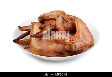 Smoked chicken wings in a plate isolated on white background Stock Photo