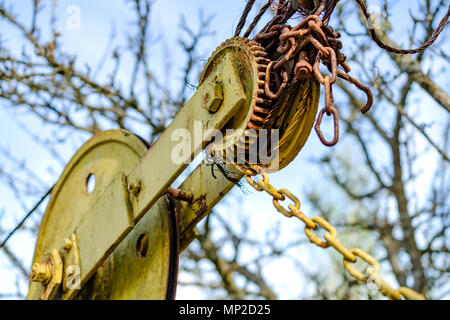 Old rusty mechanism of old and vintage winch. Rusty machinery gears and parts. Close-up. Stock Photo