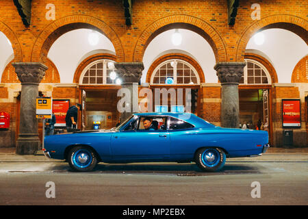 a classic 1969 Plymouth Road Runner muscle car waits outside Copenhagen Central Station, Denmark Stock Photo