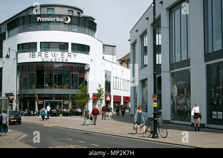 Exterior of the Brewery Quarter retail and leisure development and shoppers on the lower high street, Cheltenham, Gloucestershire. Stock Photo