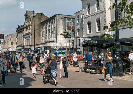 Shops / retailers, and shoppers on the High Street, Cheltenham Gloucestershire. Stock Photo