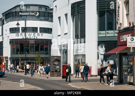 Exterior of the Brewery Quarter retail and leisure development and shoppers on the lower high street, Cheltenham, Gloucestershire. Stock Photo