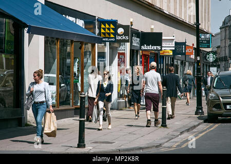 A busy street of shoppers and shops at the start of the Promenade, Cheltenham, Gloucestershire. Stock Photo